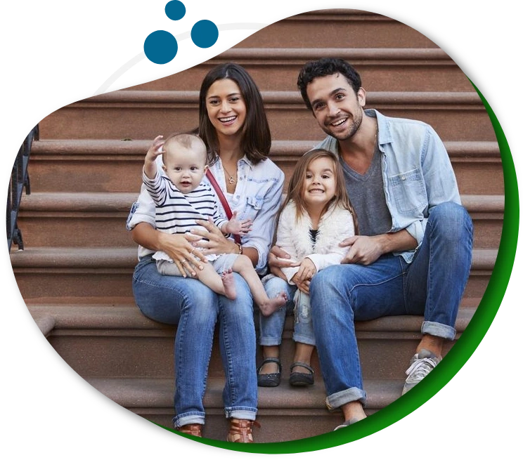 A family sitting on steps with one child in the middle.