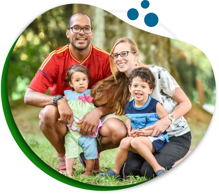 A family posing for a picture in the grass.