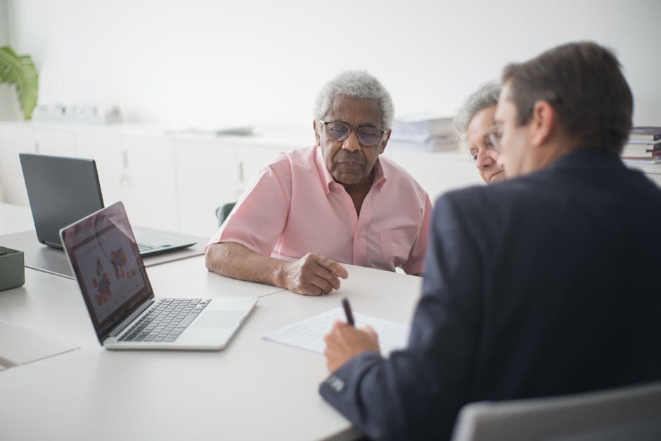 A man sitting at a table with two other people.