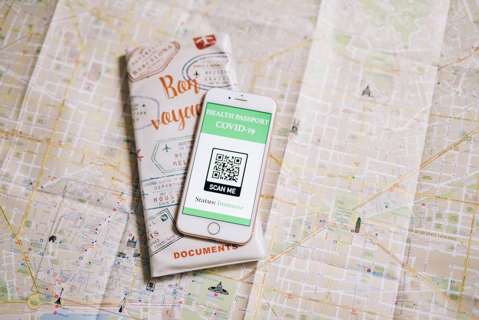 A phone sitting on top of a map next to a book.