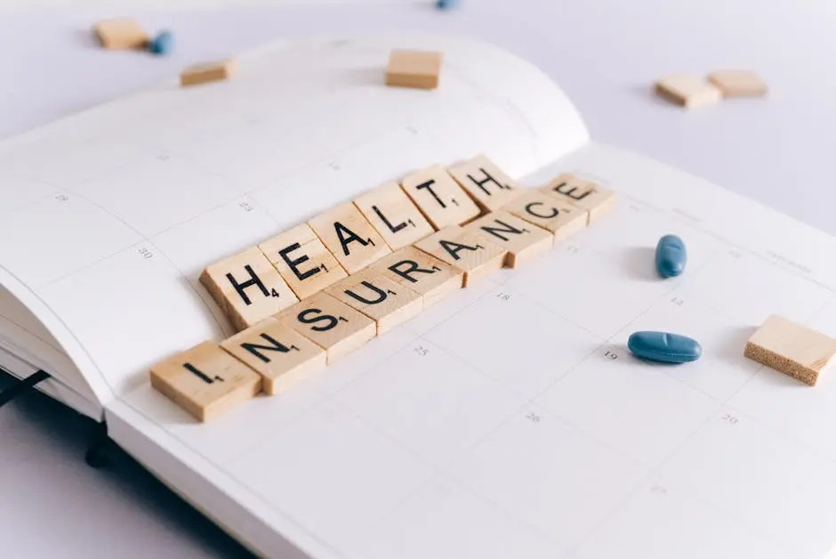 A table topped with wooden blocks that spell out health insurance.
